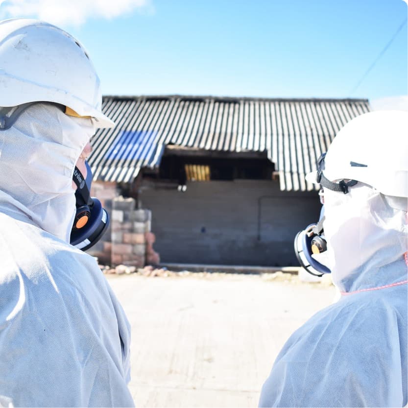 Two asbestos contractors looking at demolition project