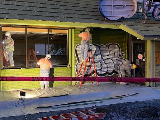 Keys Environmental Services contractors removing asbestos from restaurant exterior