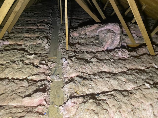 Asbestos-containing insulation located in the attic of residential building